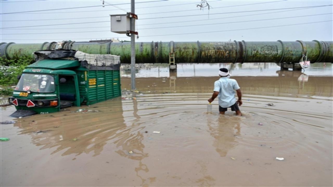 The Delhi Transport Corporation (DTC) headquarters is flooded and the employees were seen wading their way through the water accumulated at the entrance to get into the office.