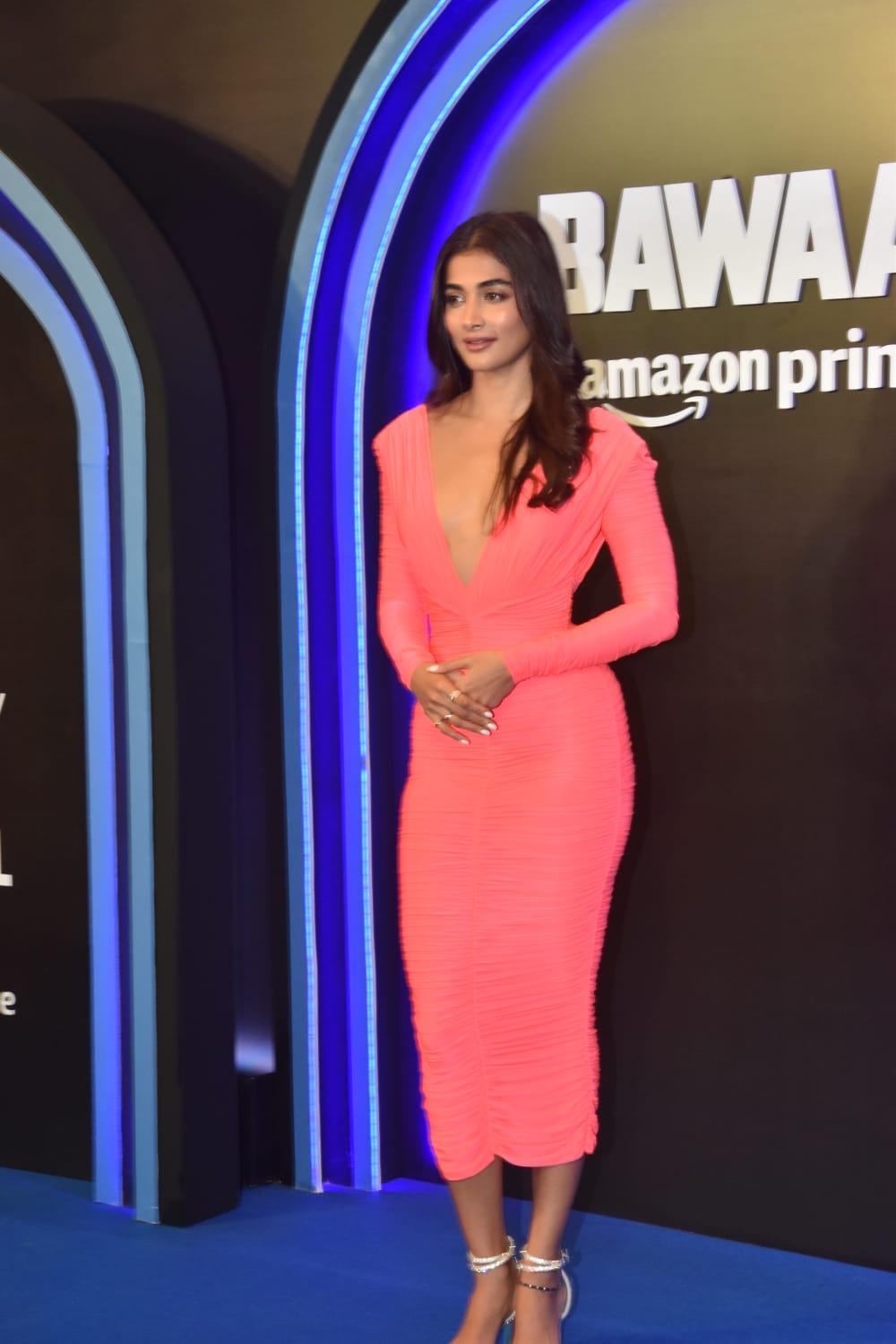 Pooja Hegde in a peach bodycon with a plunging neckline