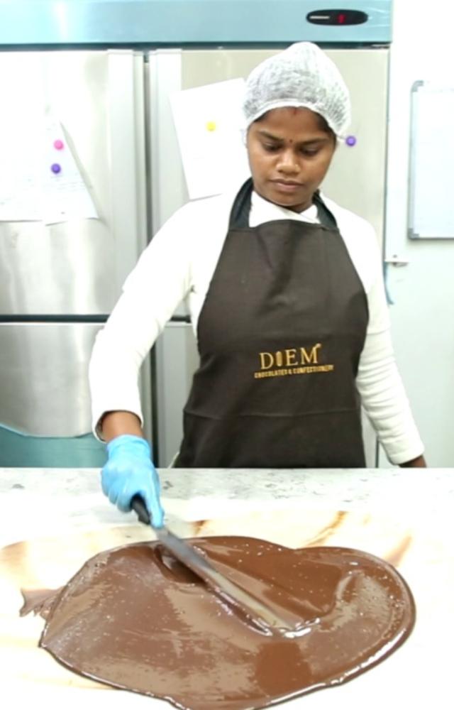 In this method of tempering chocolate, it is broken into small pieces to prepare it for melting. It is stirred gently with a spatula to avoid lumps
