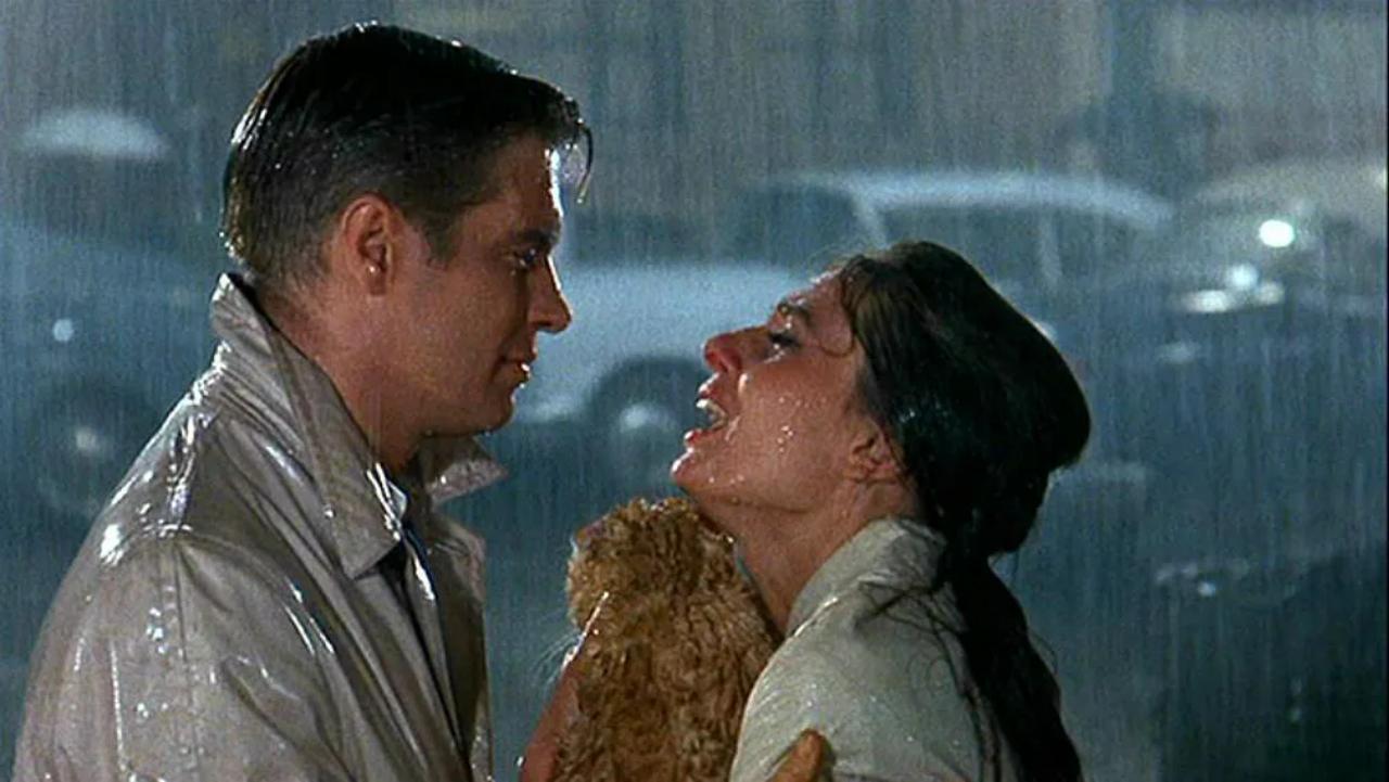 Breakfast At Tiffany's
“You call yourself a free spirit, a ‘wild thing’, and you’re terrified somebody’s gonna stick you in a cage. Well baby, you’re already in that cage.” This poignant line is delivered by Paul Varjak (George Peppard) to Holly Golightly (Audrey Hepburn). Holly finally takes the leap towards her lover (in the rain!), giving Hollywood one of its most romantic moments