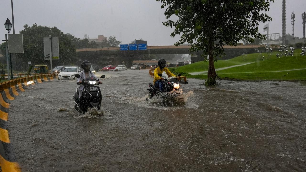 Heavy rainfall lashed Delhi on Saturday morning. Pics/PTI