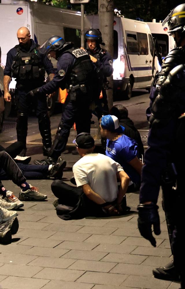 As night fell Saturday over the French capital, a small crowd gathered on the Champs-Elysees to protest his death and police violence