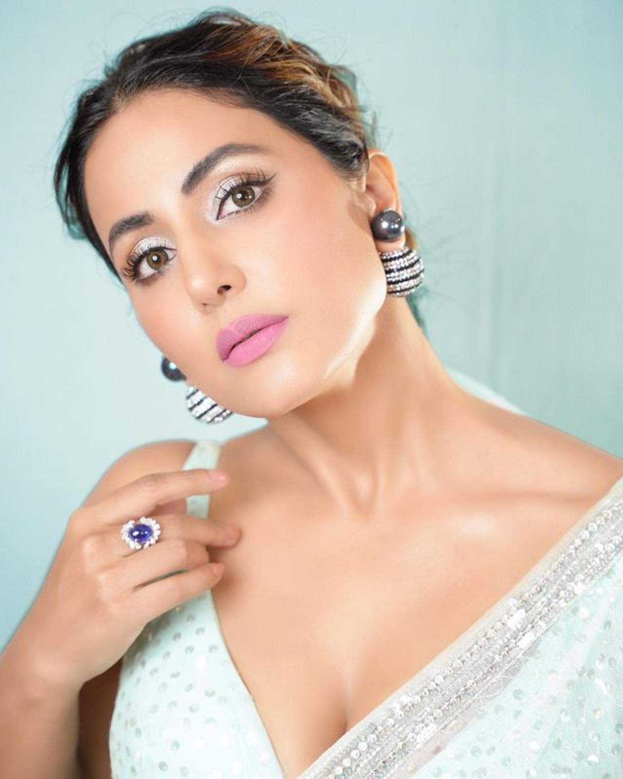 Hina has kept her make-up light as she opts for nude lipstick and shimmery eye shadow