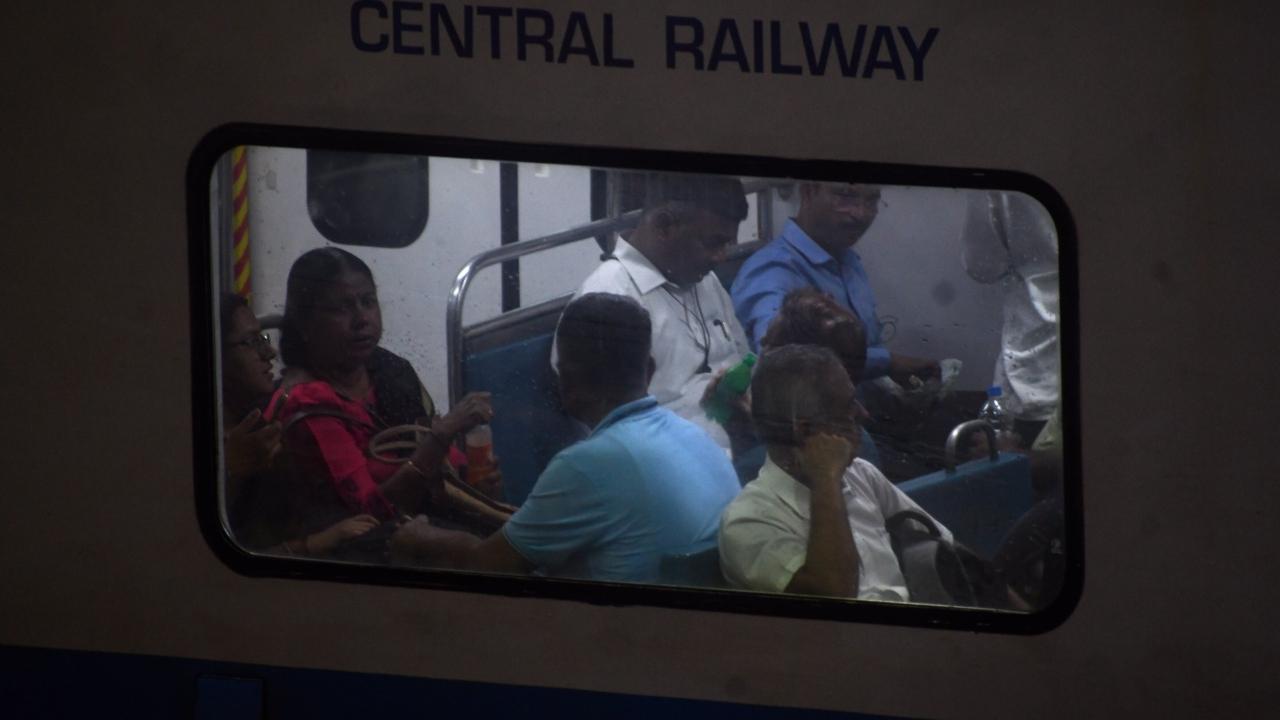 Commuters travelling in AC train at CSMT station on the Central line
 