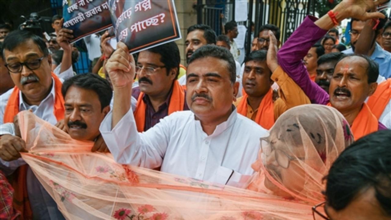 Leader of Opposition in West Bengal Assembly Suvendu Adhikari with other BJP MLAs stage a walkout from the assembly over rising dengue cases in the state during the Monsoon session, in Kolkata
 