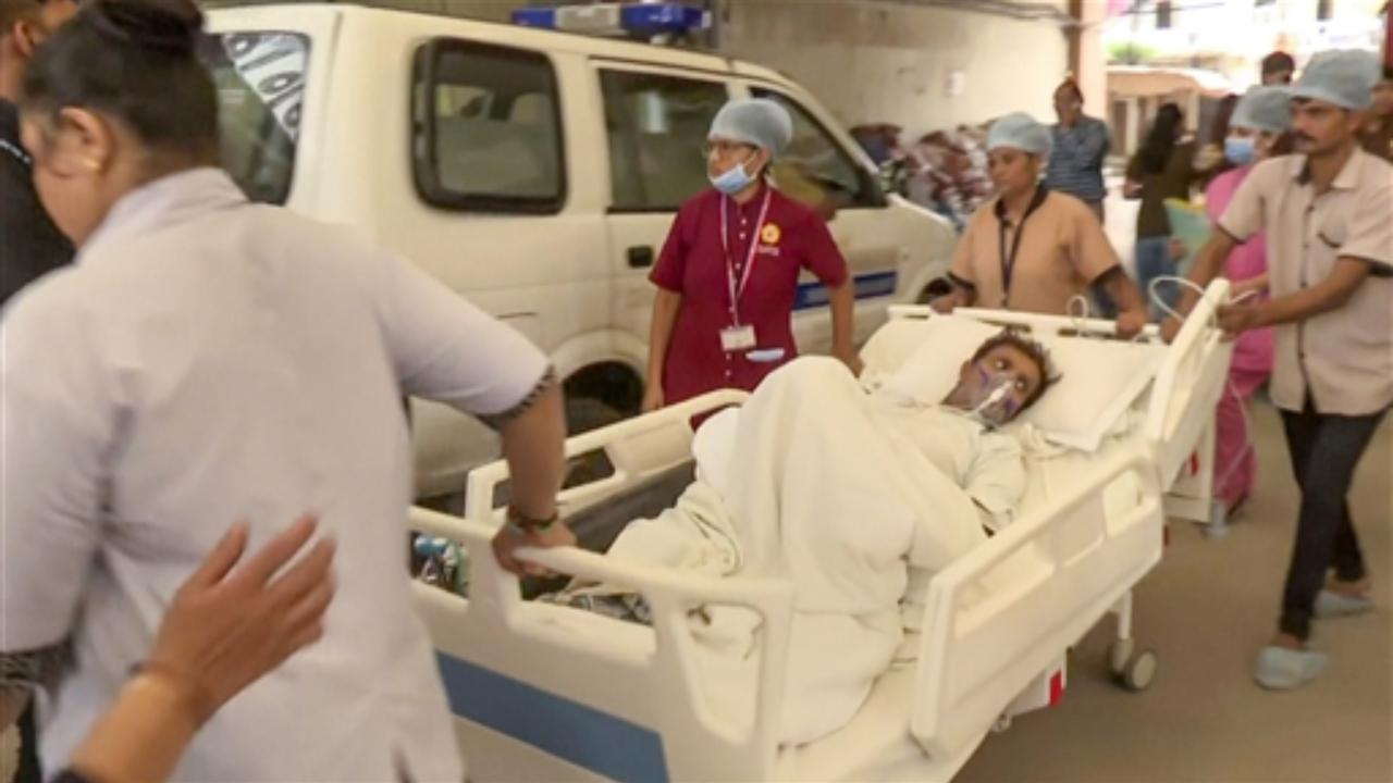 Hospital staff shift a patient after a fire that broke out at a hospital
 
