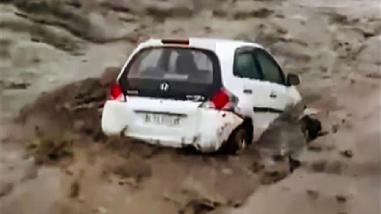 A vehicle being washed away by swollen Beas river after monsoon rains, in Manali
 