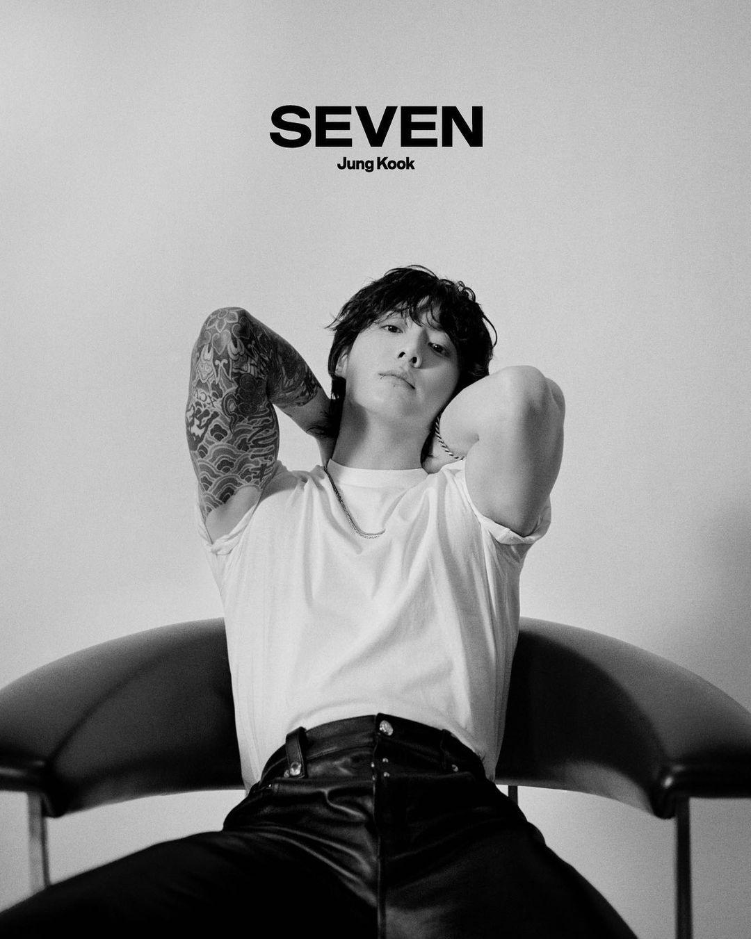 Jungkook flaunts his sleeve tattoo in this black and white picture, wearing a tee and leather pants.