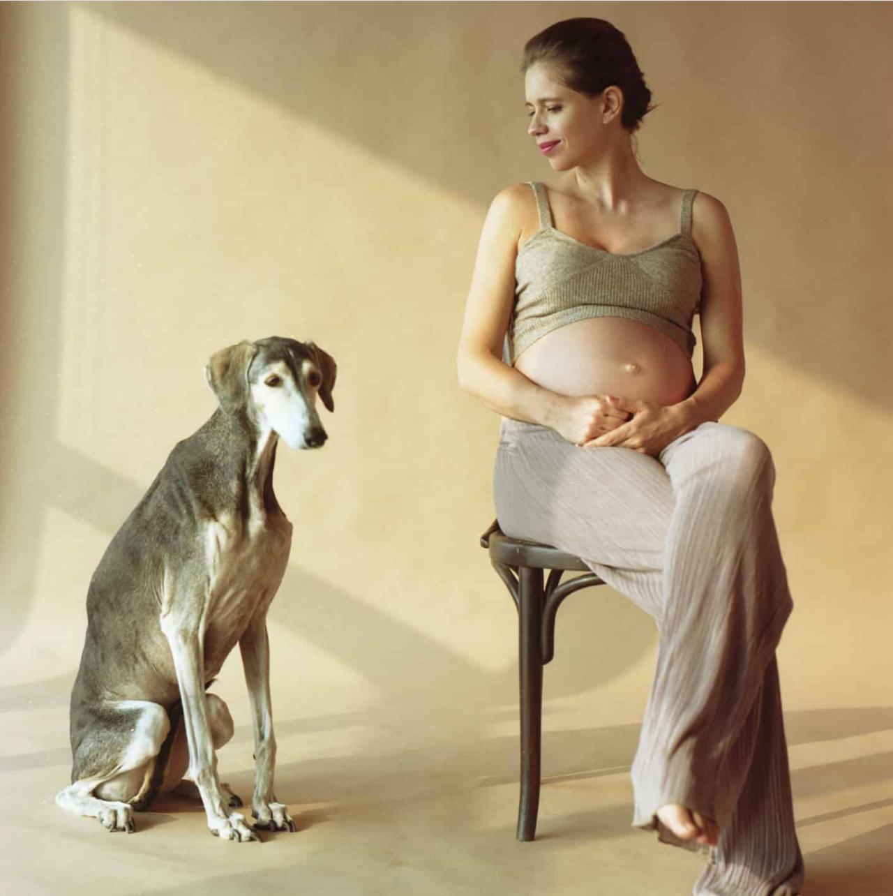 Kalki Koechlin posted a photo featuring her dear pet Kiara, who has become a cherished companion during the actress's pregnancy. In the picture, Kalki sits gracefully on a chair, proudly displaying her baby bump, with Kiara sitting affectionately by her side.