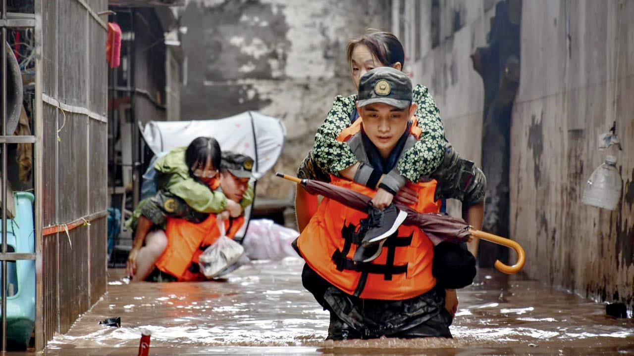 Stranded people being rescued by the armed police force. Pic/AP