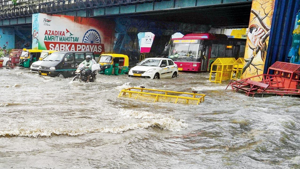 Vehicles on a waterlogged road, in New Delhi. The chief minister has announced that all schools will remain closed on Monday