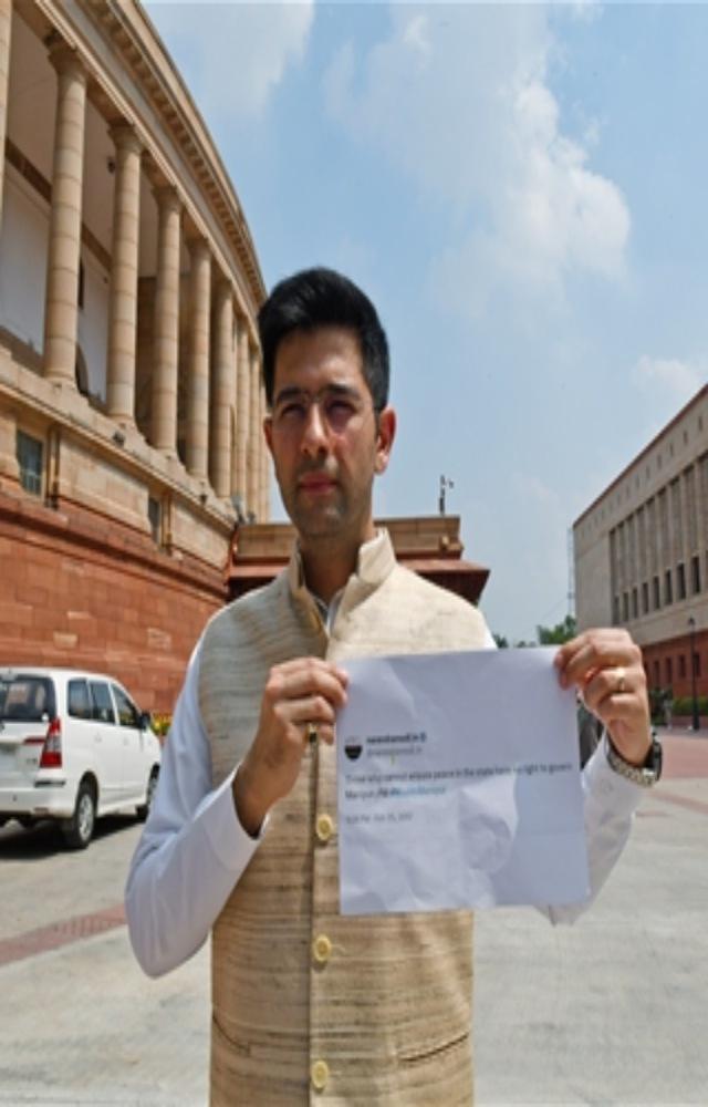 Aam Aadmi Party Rajya Sabha MP Raghav Chadha shows Prime Minister Narendra Modi`s tweet at Parliament House during the Monsoon Session, in New Delhi on Friday.