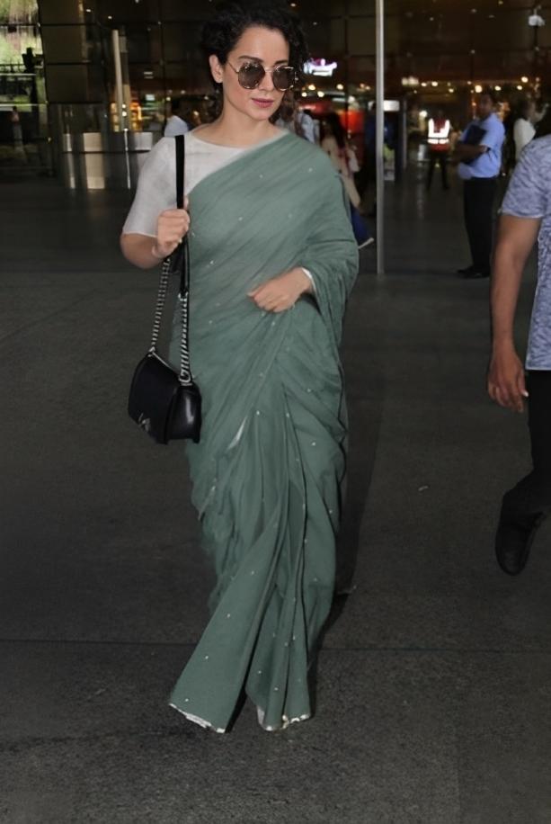 Kangana brought her signature flare to the outfit with black sunglasses and a black bag to match