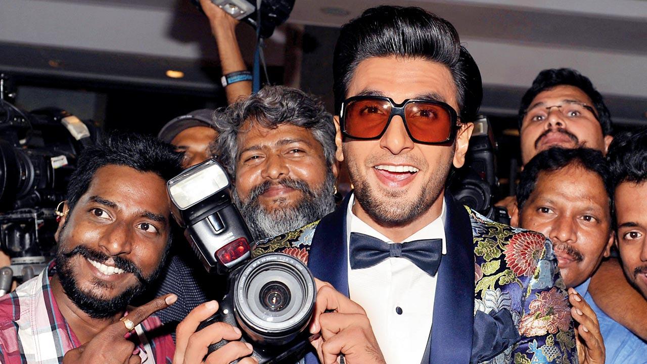 Singh shares a light moment with photographers at an awards ceremony in 2018. Pics/Getty Images