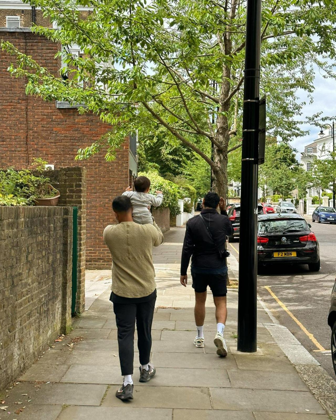 Little Vayu is having the time of his life riding on his dad's shoulder