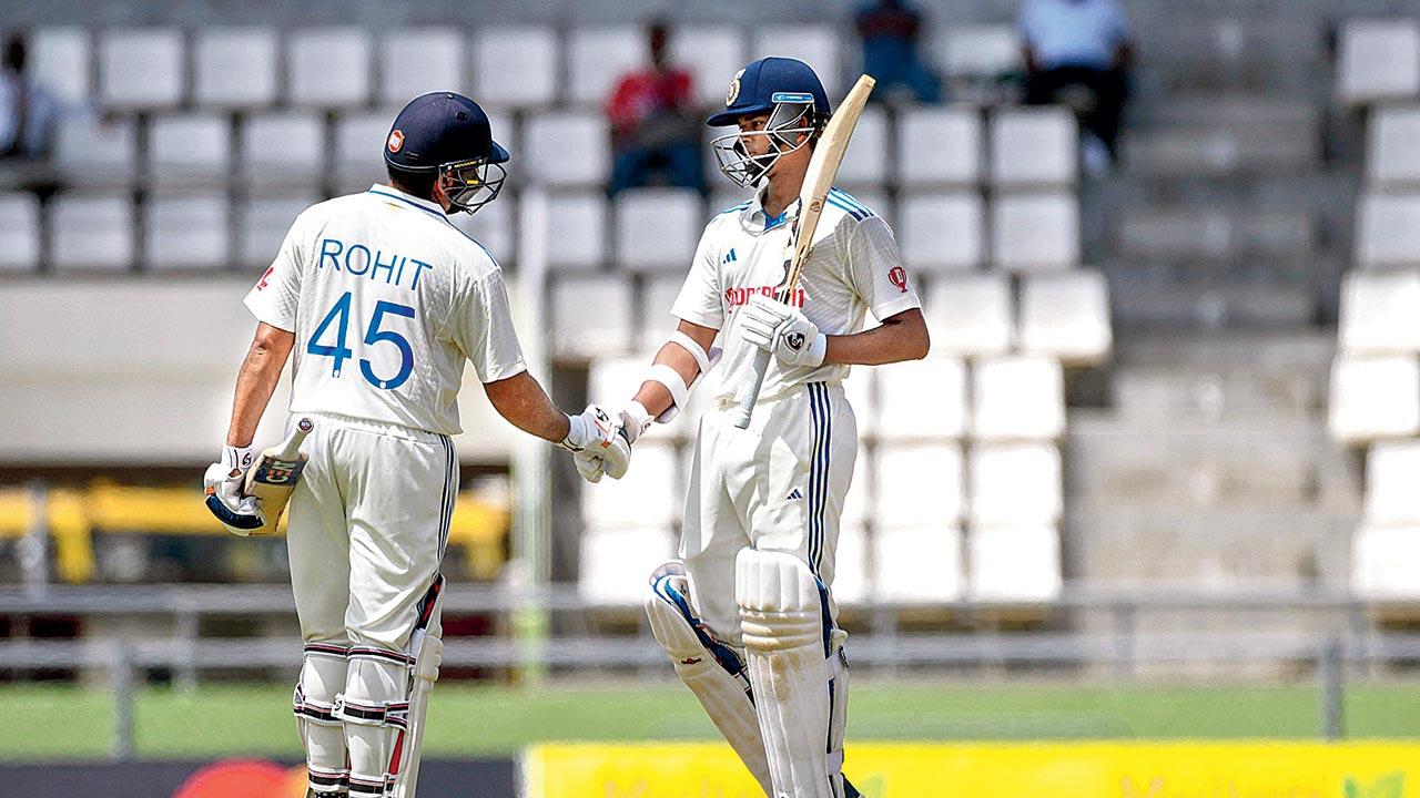 India skipper Rohit Sharma is congratulated by Yashasvi Jaiswal on reaching his half-century on Day One of the second Test against  West Indies at Port of Spain yesterday