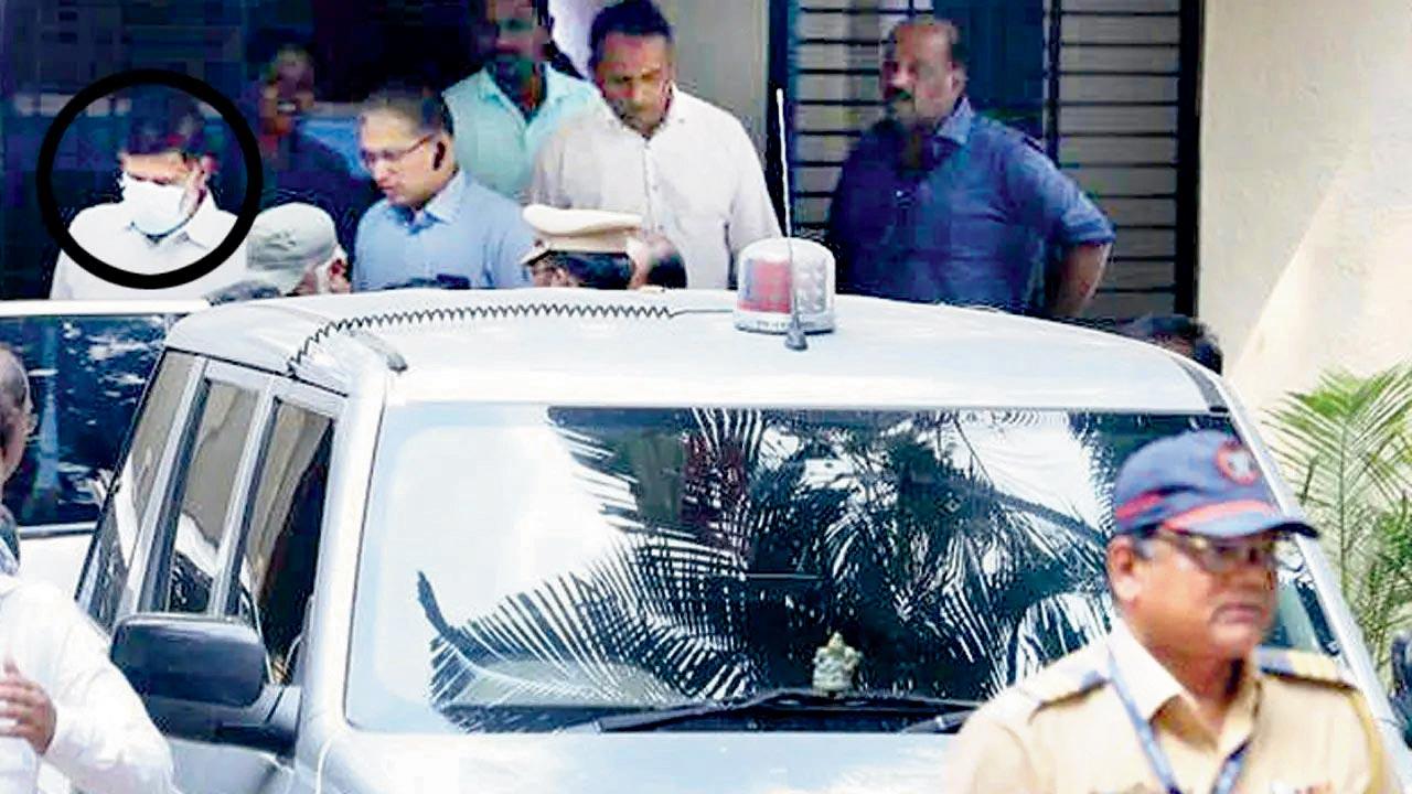 Pradeep Kurulkar (in white face mask) produced in court in May