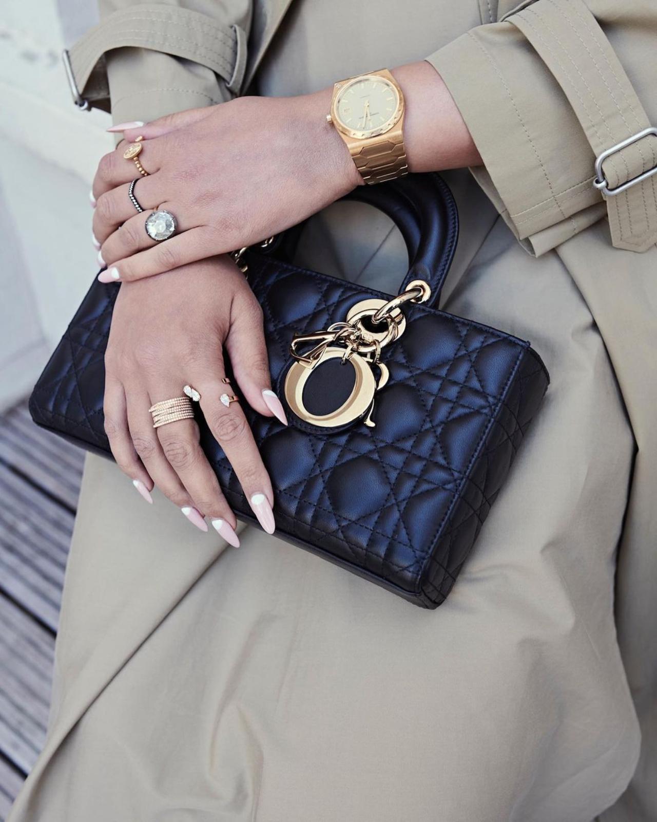 Sonam styled the ensemble with a black hat embroidered with lace, a Dior top handle bag, and heeled loafers. She chose striking gold jewellery, including statement rings, a watch, ear cuffs, and earrings from Dior and Repossi