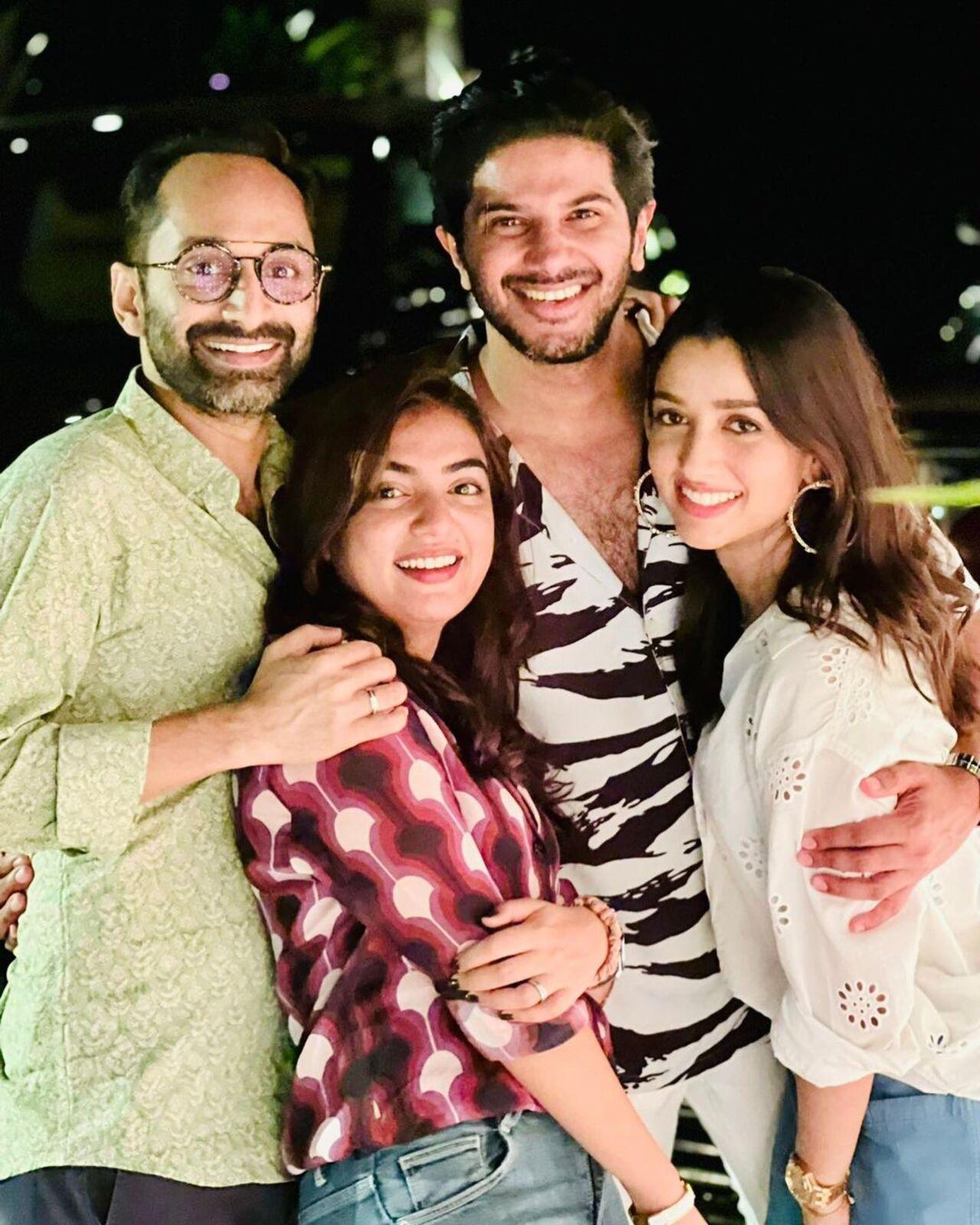Fahadh Faasil and Nazriya pose with Dulquer Salmaan and his wife Amal