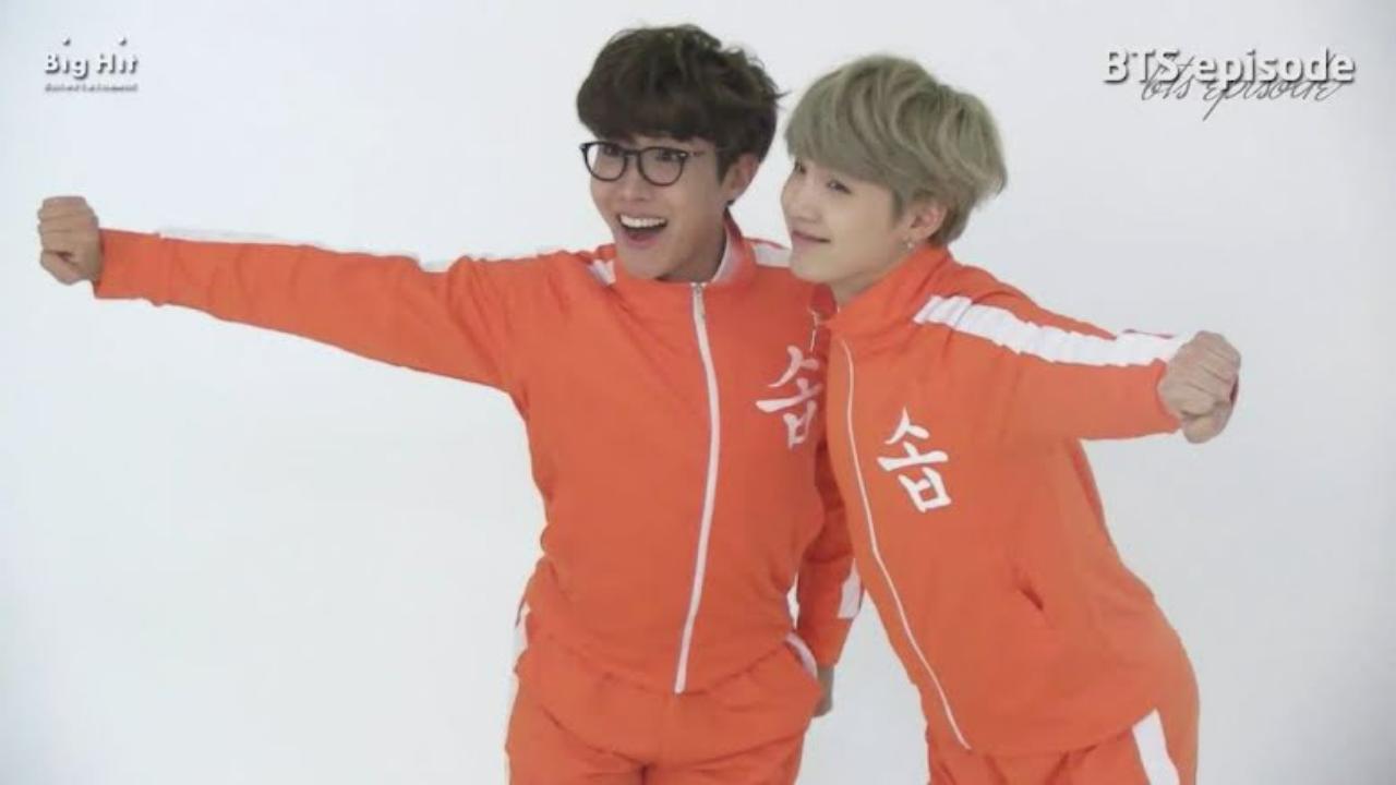 SOPE – Suga and J-Hope need so reason to goof around together. They look very cute in mandarin-coloured jumpsuits with a white strip in a behind-the-scenes video of preparing for a unit song