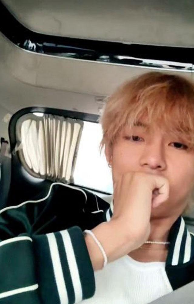 Dressed in a white tee, green jacket and sporting blonde hair, V kept the look casual