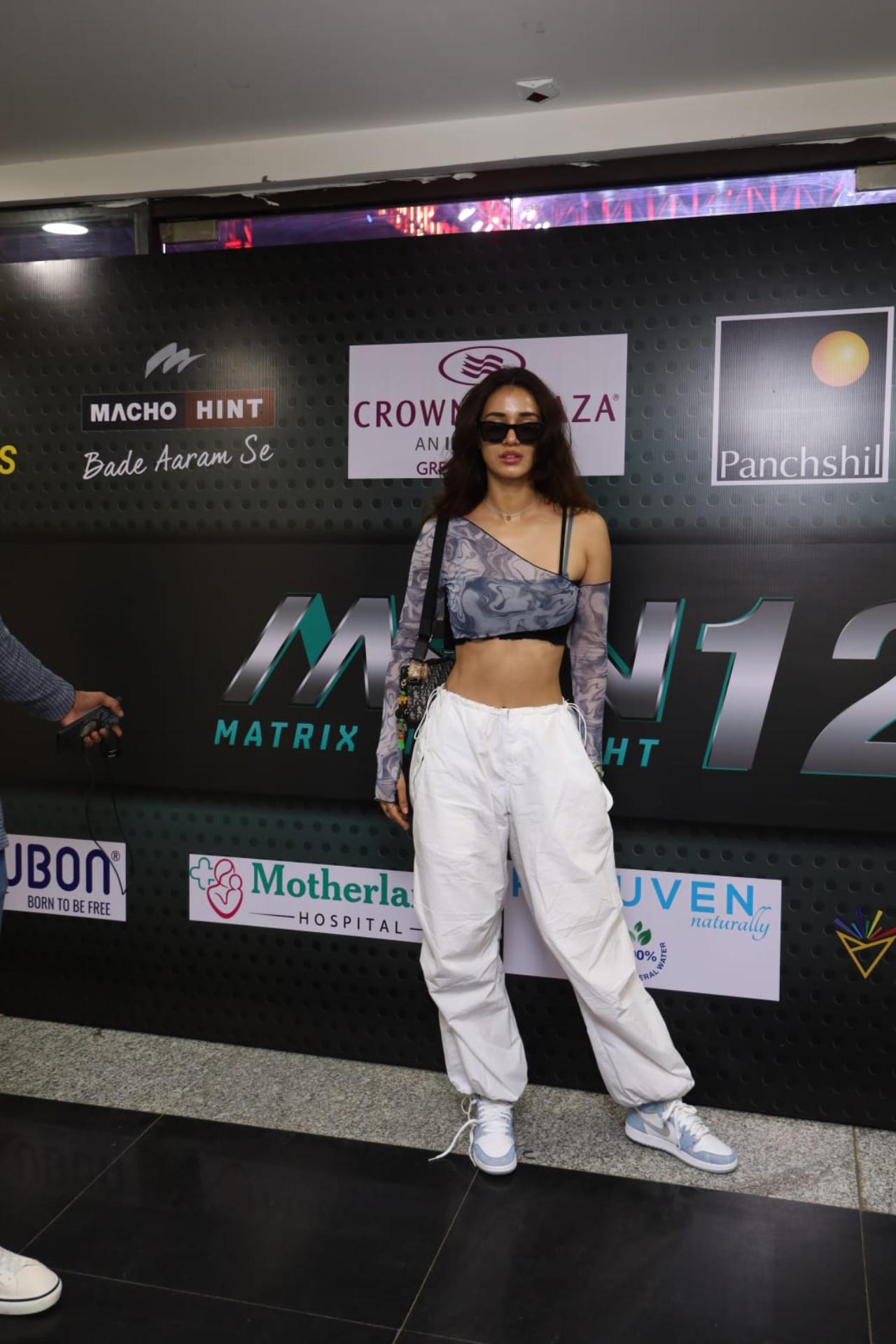 Disha looked chic in a one-shoulder fitted full-sleeved crop top paired with white baggy pants. She teamed her outfit with white and blue coloured sneakers, and left her hair open
