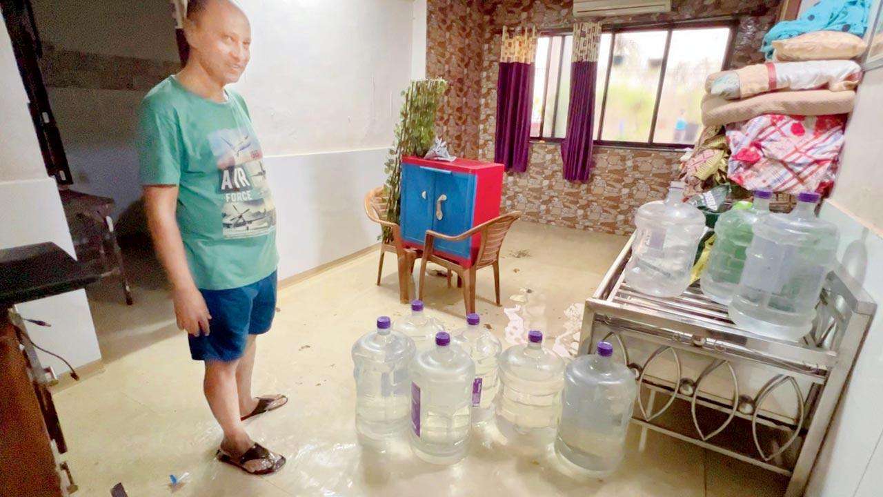 Prakash Pevekar, a resident of C Colony, in his waterlogged home