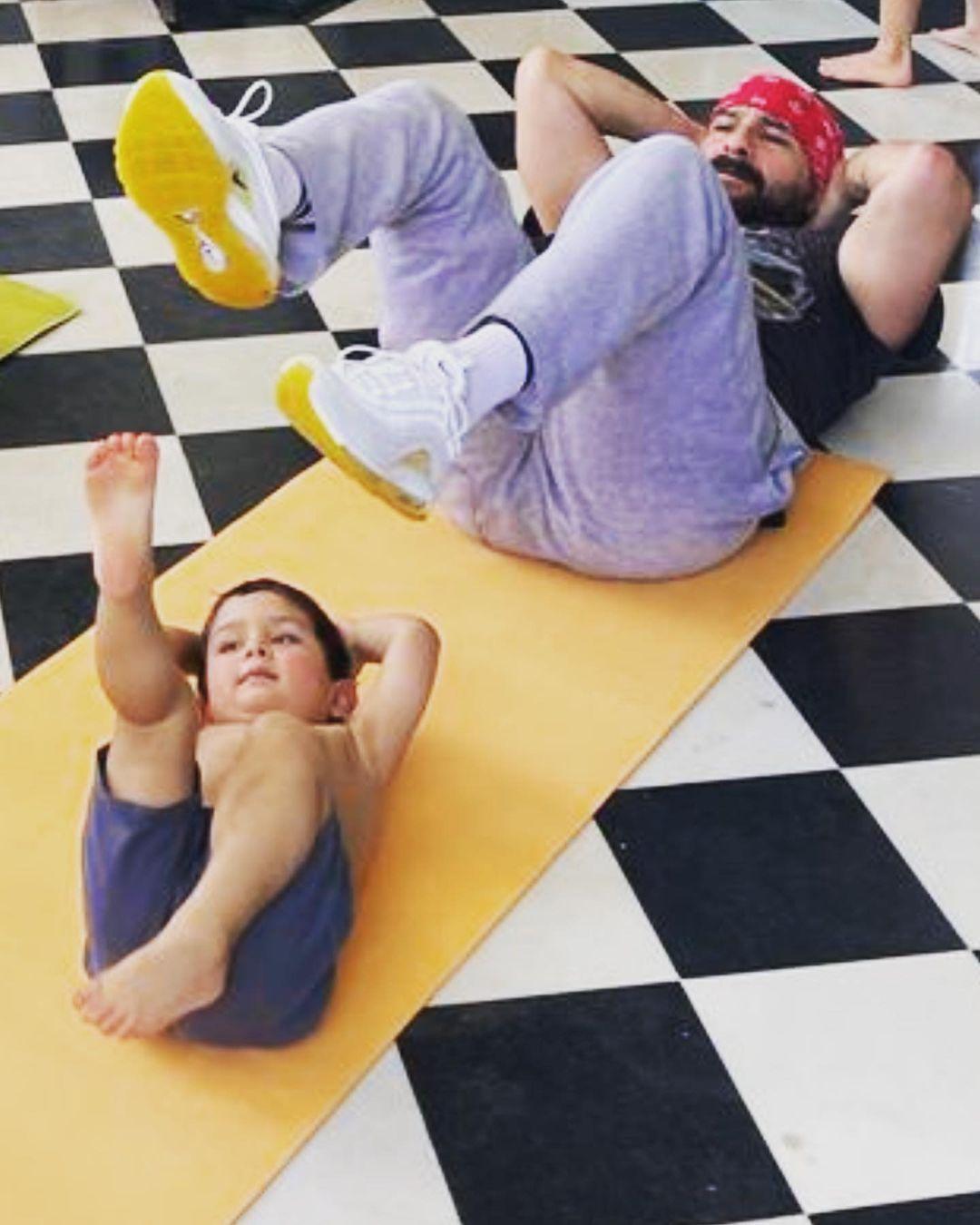 Kareena shared two photos. In the second one, Saif and their youngest son Jeh are seen sharing a mat as they try to pull off bicycle crunches, or whatever this is