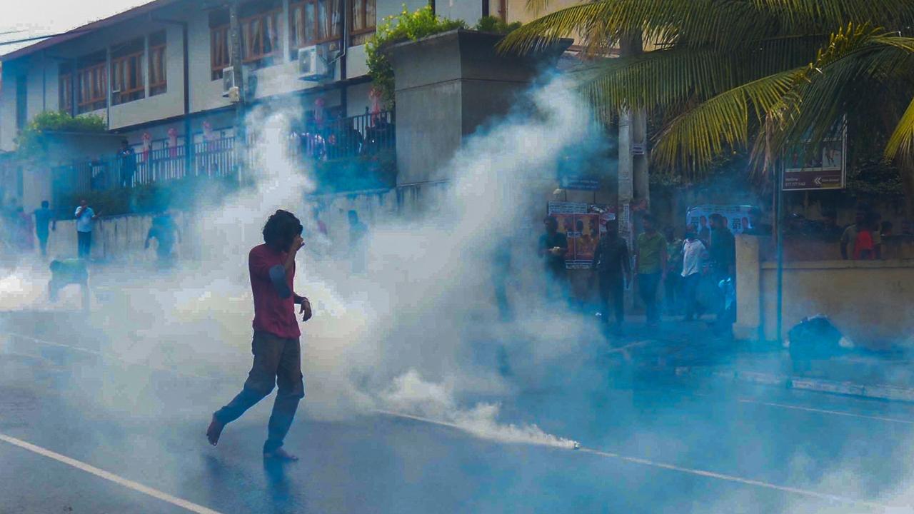 Police use tear gas to disperse anti-government demonstrators.