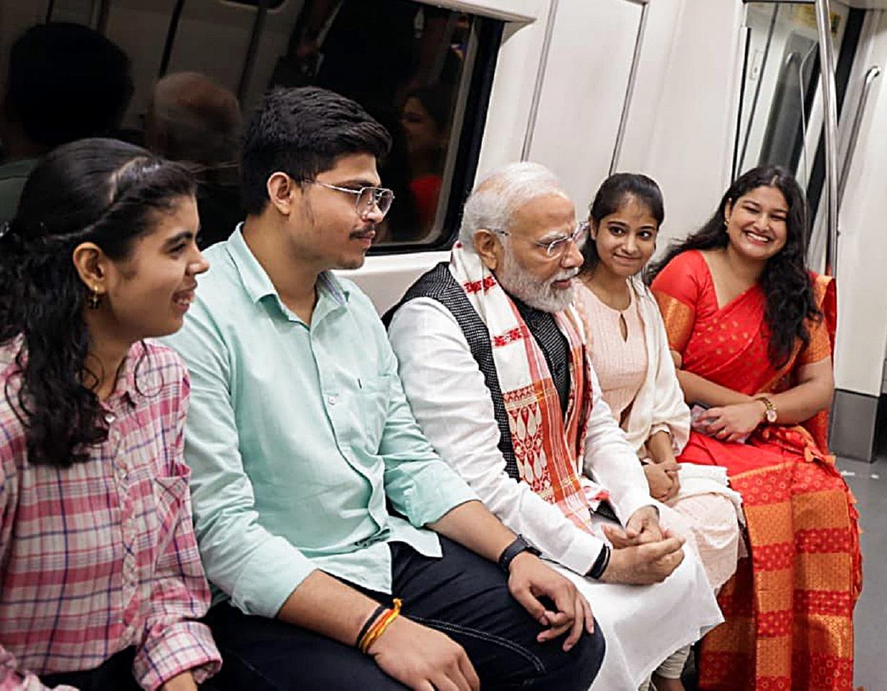 PM Modi could be seen interacting with people in Delhi Metro on his way to attend the centenary celebrations of Delhi University