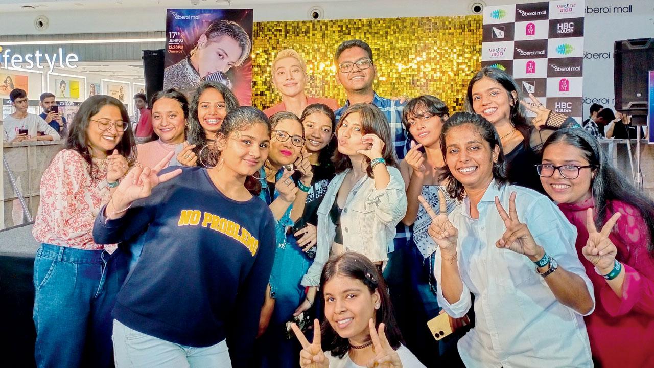 Aditya Mhaske (to the right of Aoora) poses for a picture with the K-pop idol and other fans after the concert