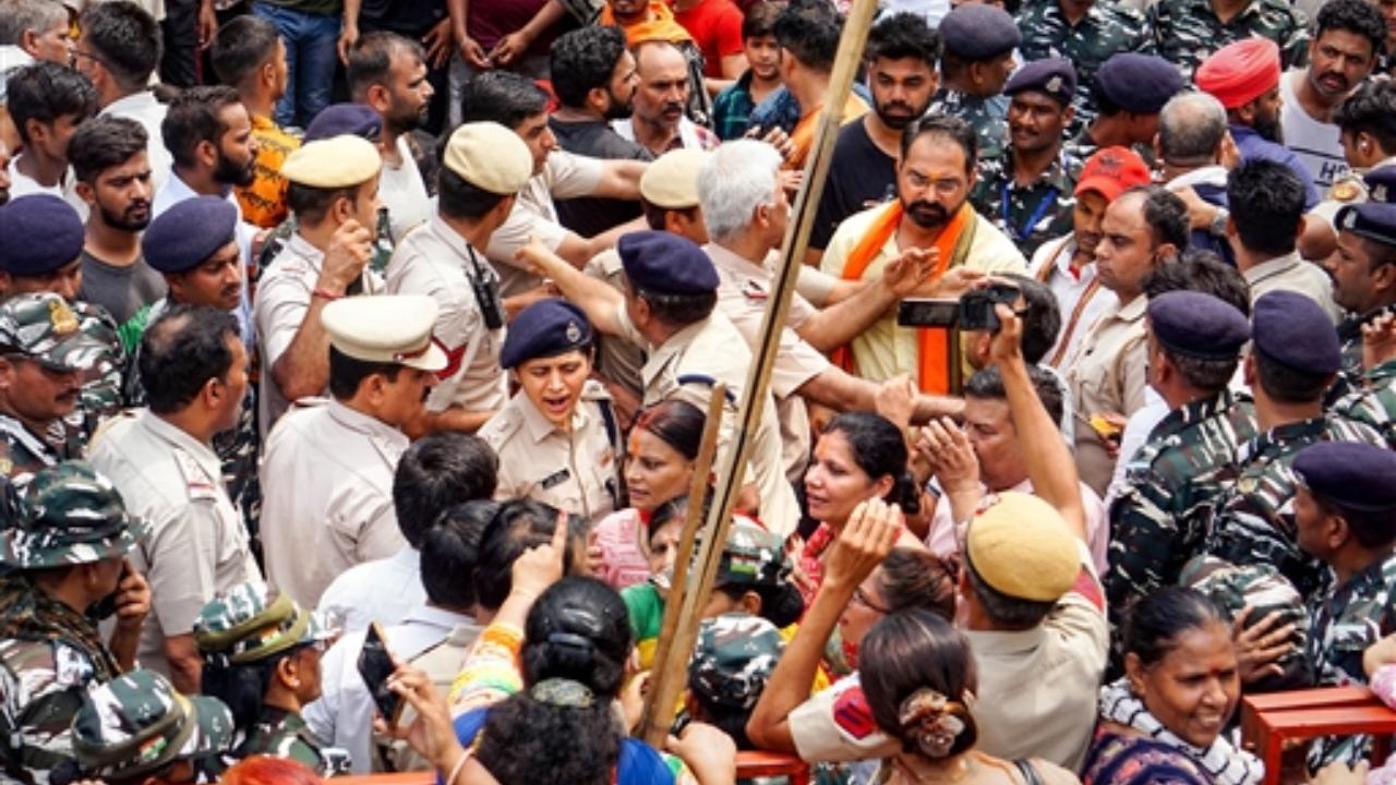Meanwhile, women were seen with sticks in their hands opposing the removal of a portion of a temple