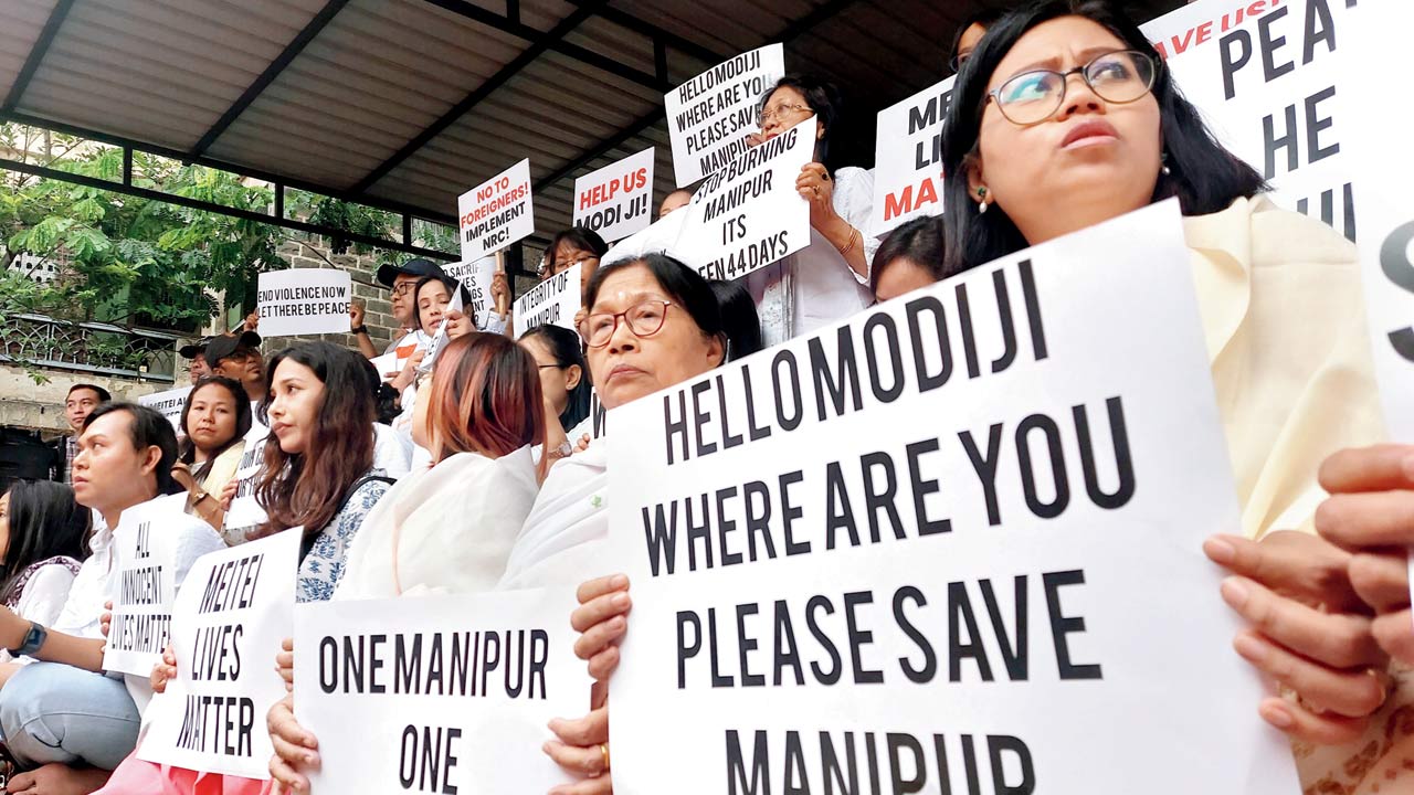 Members of the Meitei community protest, seeking immediate end to the violence in their native Manipur, in Pune, on Monday. Pics/PTI