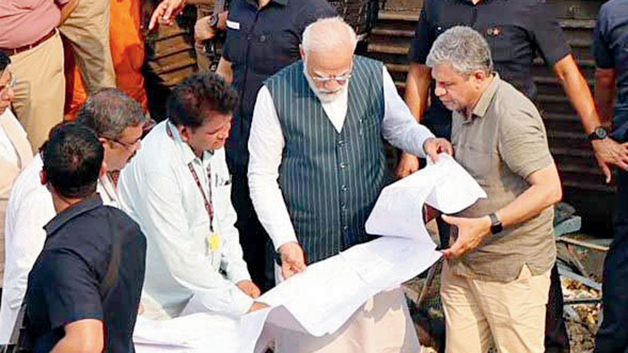 Prime Minister Narendra Modi takes stock of the situation at the site of the accident involving Coromandel Express, Bengaluru-Howrah Express and a goods train, in Balasore district 