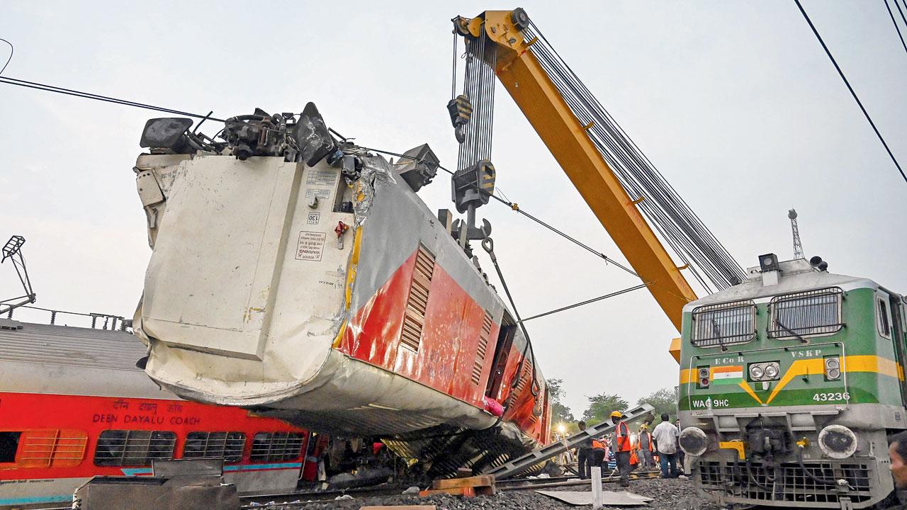 Cranes used to recover victims’ bodies from a carriage wreckage of a three-train collision near Balasore. PICS/PTI
