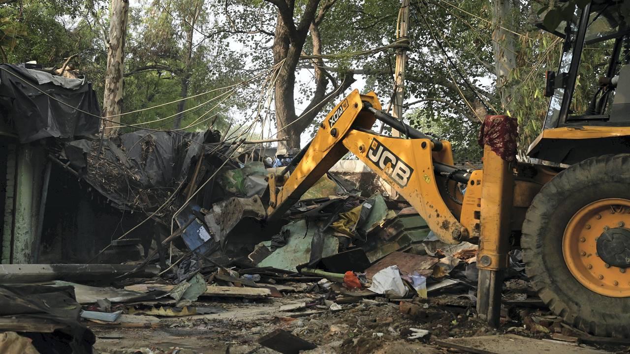 A bulldozer being used to demolish illegal structures during an anti-encroachment drive near Pragati Maidan.