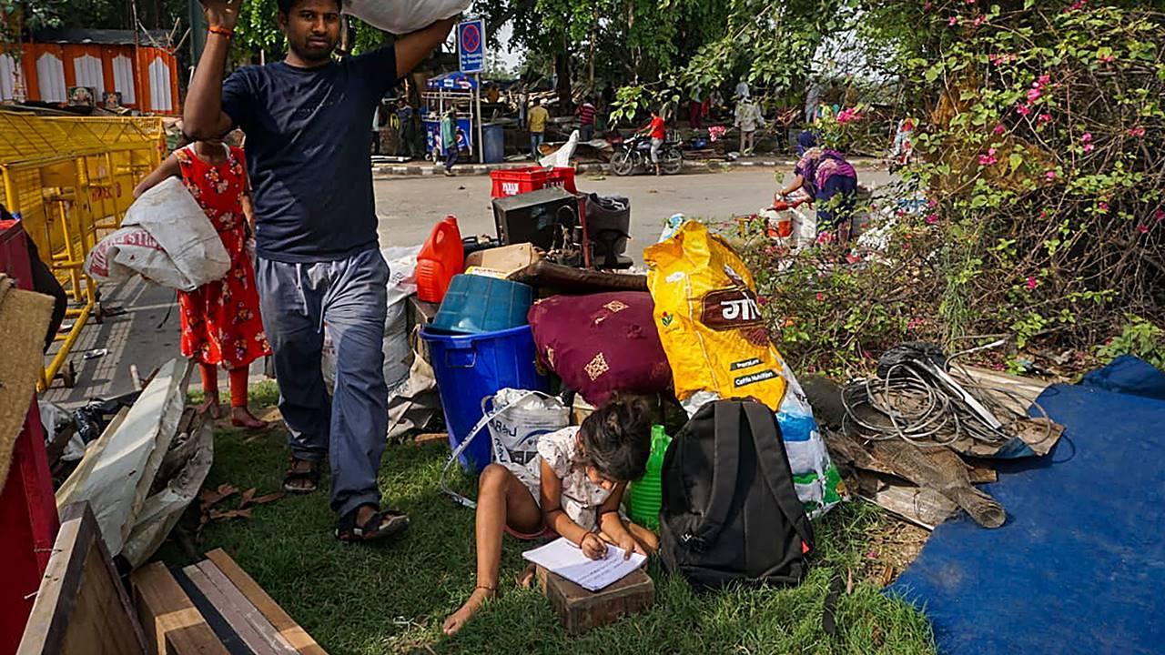 Residents shift their belongings after an anti-encroachment drive near Pragati Maidan, in New Delhi, Thursday, June 1, 2023.