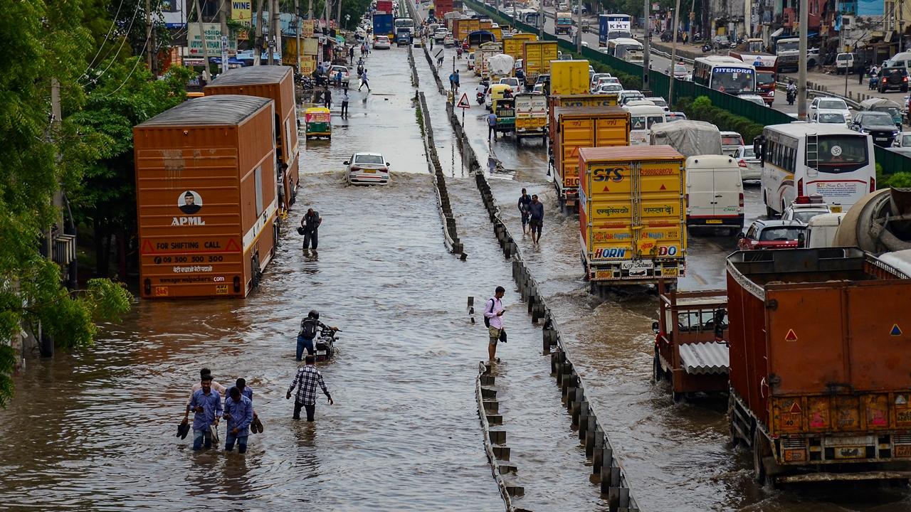 Delhi-Jaipur highway (NH 48) near Narsingh Pur Chowk gets flooded due to heavy rainfall in Gurugram, causing disruptions in transportation.