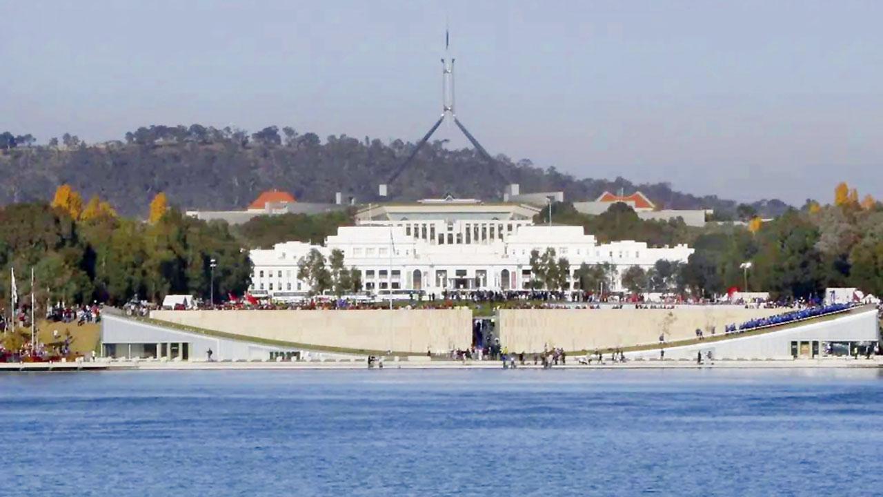 The Parliament House, behind Lake Burley Griffin in Canberra. Pic/AP