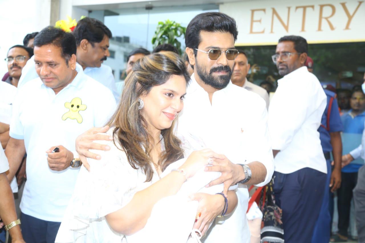 With a wide smile, Ram Charan and Upasana were seen stepping out of the hospital with their litte one in their arms. They covered the baby's face and wrapped her in a white cloth. The couple was showered with rose petals as they stepped outside the hospital