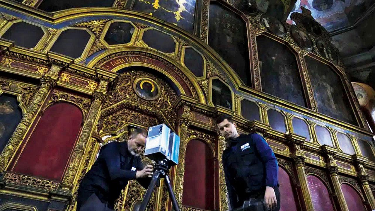 Volunteers set up a scanner at the All Saints Church in Kyiv. Pic/AP