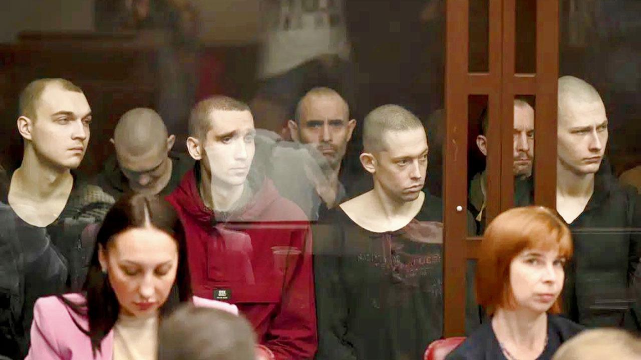 The soldiers inside a glass cage during a hearing. Pic/AP