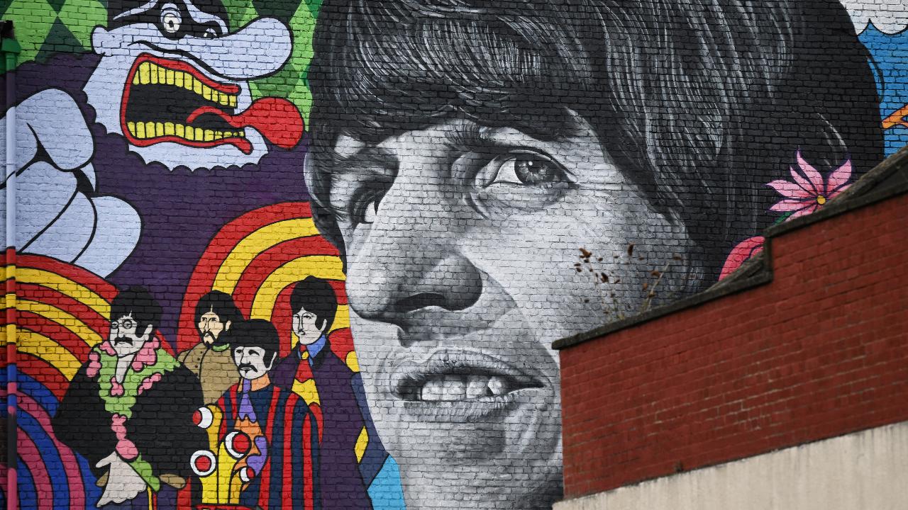 A photograph taken on March 9, 2022 shows a mural depicting former Beatles member Ringo Starr and painted by Liverpool artist John Culshaw, on the facade wall of The Empress Pub in Toxteth, Liverpool, north west England. The mural has been painted close to places connected with the former Beatles including his birthplace and childhood home. Photo Courtesy: AFP