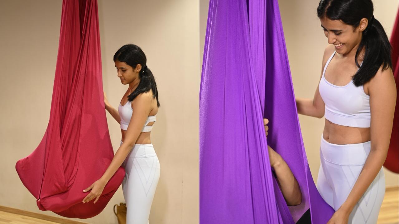 The fabric used in aerial yoga is typically made of strong and durable material, such as nylon tricot or parachute fabric. The use of the hammock requires practitioners to pay close attention to their body's position and alignment in space. The hammock acts as a prop, assisting in achieving deeper stretches and poses that may be challenging on the ground. Photo Courtesy: Niyoshi Marfatia