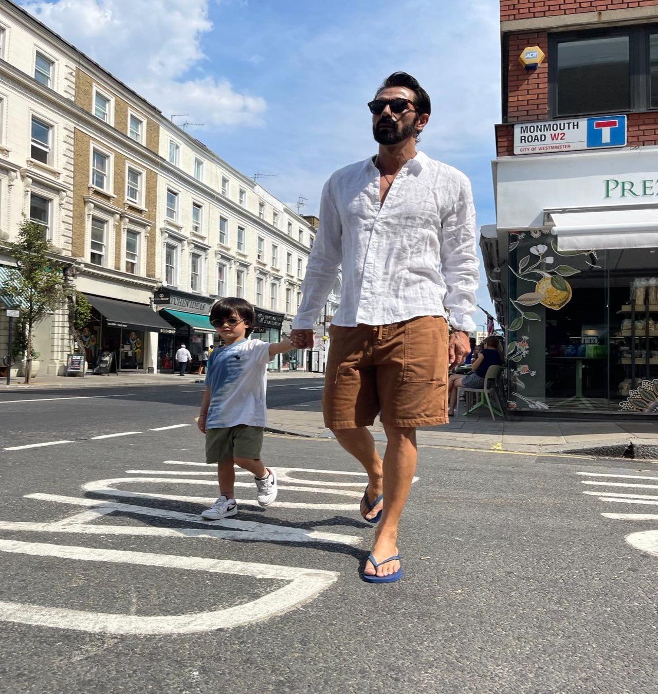 Boss baby and dapper dad stroll across the street, Beatles style!