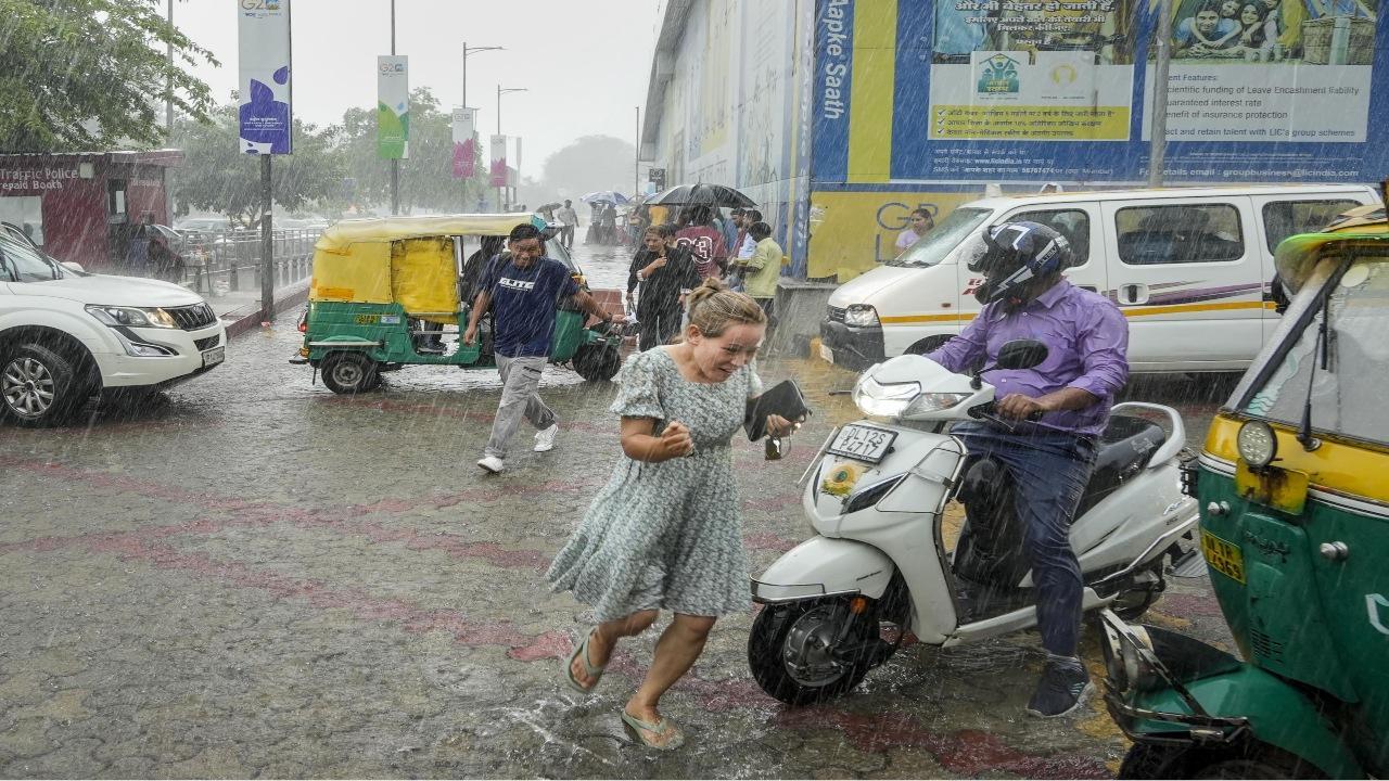 Some parts of Delhi witnessed waterlogging after the city received light to moderate rainfall on Friday, causing inconvenience to the people. Photos/PTI/ANI