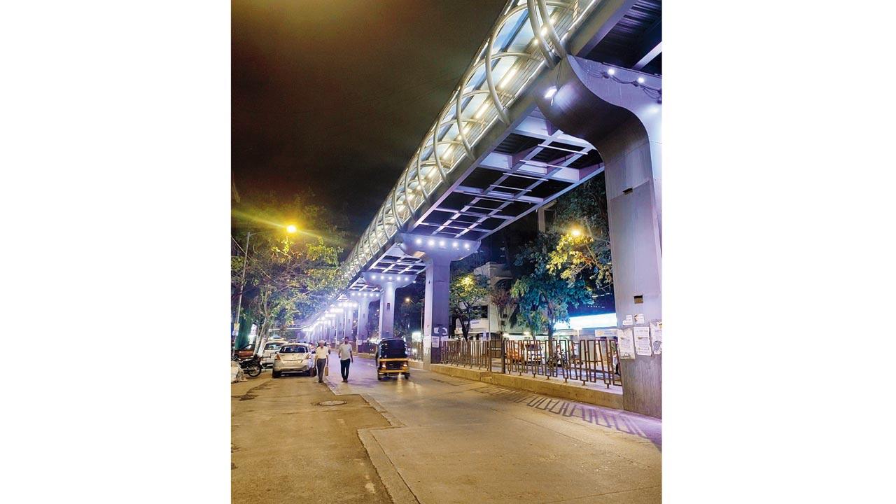 The well-lit street below the skywalk