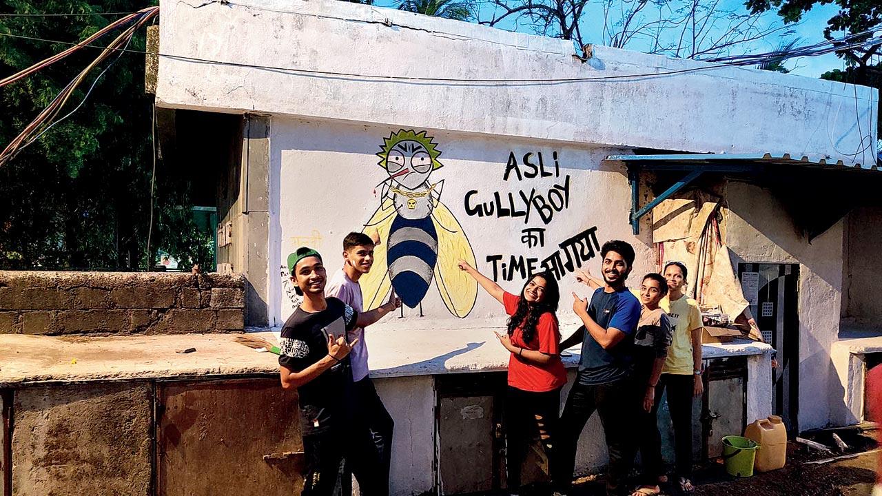 The doctors pose by the graffiti