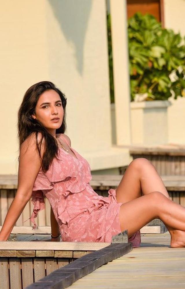 She shared several pictures in a strappy pink dress with a thigh high slit