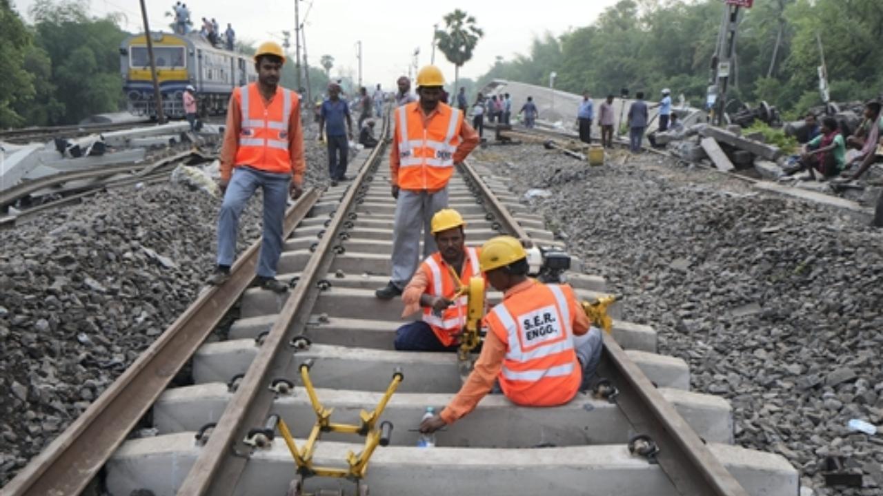 Workers restore railway tracks at the end of rescue and search operation after an accident involving three trains, near Bahanga Bazar railway station in Balasore district (Pic/PTI)